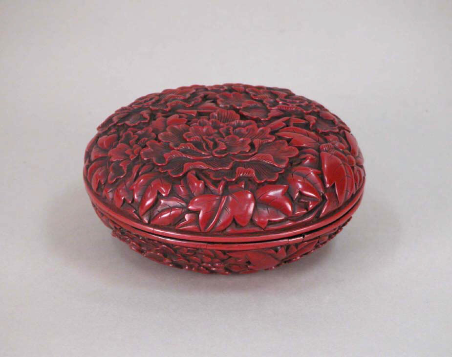 Museum photograph of a carved red lacquer box with peony decoration